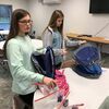 Shelby Long and Makayla Whiting fill backpack for foster kids. 