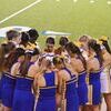 Cheerleaders praying for one of their own that had been taken to ER during the game.