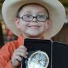 Cole Fletcher showing off his belt buckle. Cole won reserved Grand Champion with his pony Peanut and his belt buckle with his horse Skip for Showmanship.