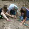 Ashlynne, Dustin, and Charlotte work to remove a root-stob from the nature trail pathway. ​