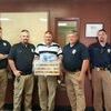 L-R Officer Matt tucker, Officer Jonathan Powell, Lieutenant Greg Miller, Chief Jim Tucker and Sergeant Brad Bazarrow with the fruit basket.