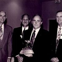 Richard Mason of the Arkansas Wildlife Federation presenting award to Chuck Dees, Bill Spicer, and Hugh Cockrell of Waste Management