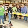 The School Board watches as Justin Midkiff and Tyler Corley demonstrate the robot