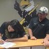 Kayla West signing her letter of intent