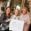 Project Director Wendy Talbot, left, and GDAH Executive Director Mellie Bridwell, right, accept check from Susan G. Komen for the Cure-Arkansas Affiliate Executive Director Sherrye McBryde, center, at presentation luncheon in Little Rock.