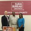 South Arkansas County Farm Family, James and Eddie Phillips with Arkansas County Farm Bureau President, Trent Dabbs.