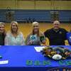 Carlee Cox signs her letter of intent to UAM, as her parents Tina and Jeremy Cox look on.