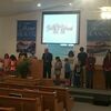 County Judge and Preacher Eddie Best pray with the students of his congregation at Gillett Baptist.