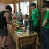 4H members look on as a community member grabs a quick snack.