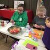 Emily Golleher and Chloe-Belle stuff eggs for the upcoming hunt at the Dewitt City Park.