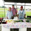 Billie Jo Gardner, Paul Gardner, and Gene Jones display some of the produce they have grown and offer for sale at the DeWitt Farmers Market.