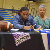 Malik Brasfield signs with Arkansas Baptist College with his Father, Micheal Brasfield and Grandmother, Ruth Rone.
