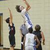 #24 Seth Courtney goes up for a successful shot for the Jr. Dragons, as #1 Lathan McKenzie watches for rebound.