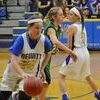 Abby Noblin goes in for the Jr. Dragonettes, while Jessalyn Ahrens blocks defensive.