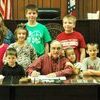 Arkansas County Judge Eddie Best signs 4-H Proclamation during Quorum Court while 4-H members watch.