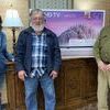 Tammy Mannis, Stone Bank Branch Manager, and David Jessup, Senior Vice President,  present William Jackson of DeWitt (center), a 50-inch TV as the grand prize winner.